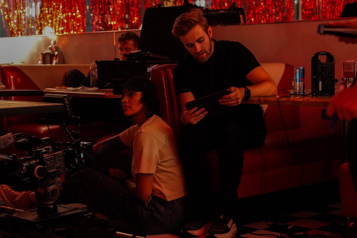 Crew reviewing a take in a diner booth